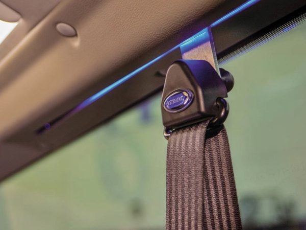 Black, adjustable wheelchair seatbelt inside a Volkswagen Caddy Maxi.